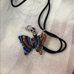 NWT glass butterfly amulet with 24 in long braid
